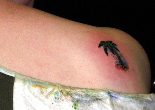 Small Black Palm Tree Tattoo On Right Back shoulder